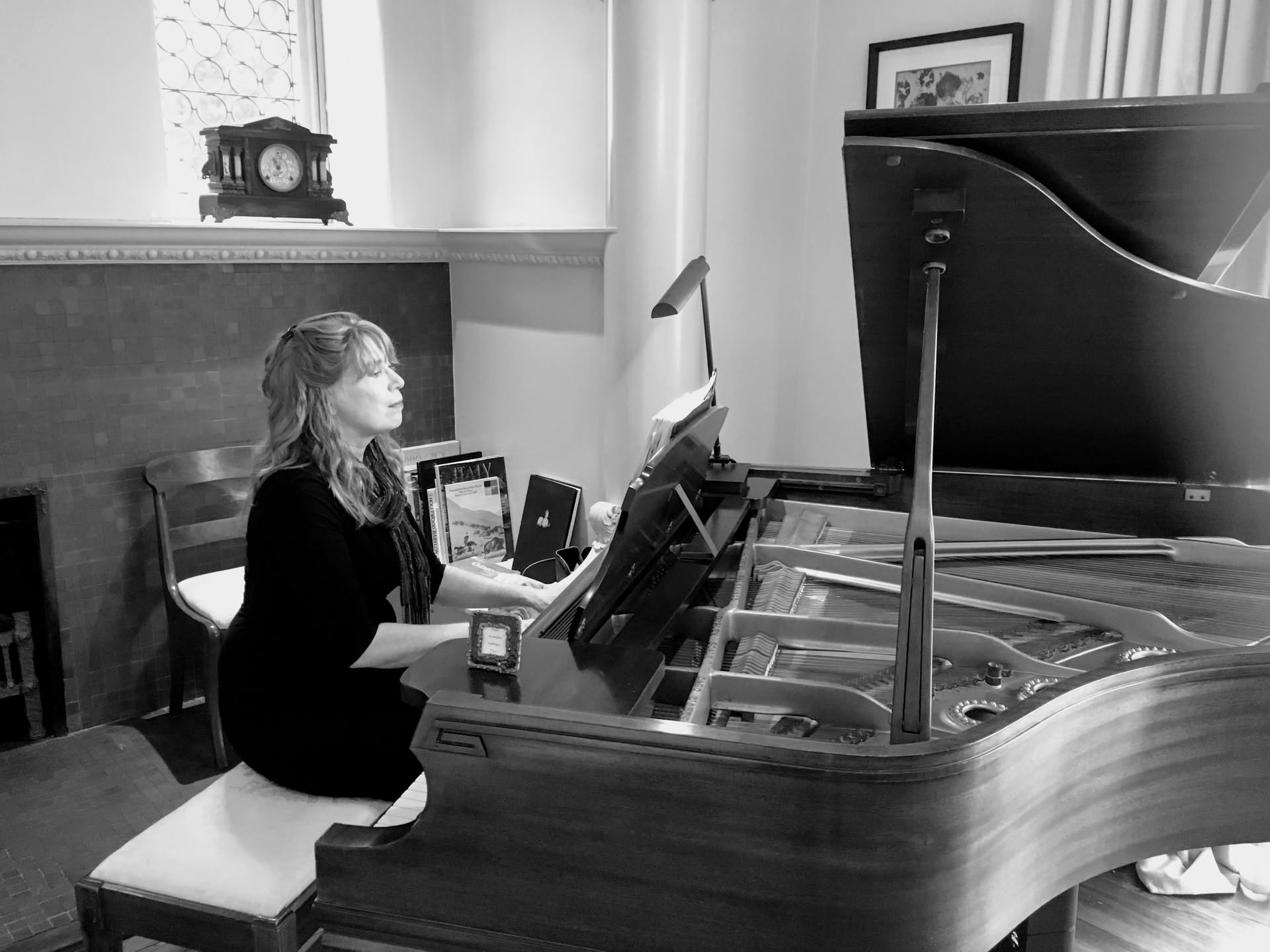 Black-and-white portrait of Jenny playing a grand piano