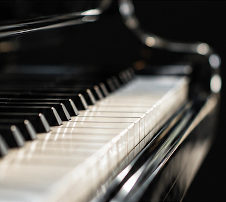 A close view of a glossy black piano and its keys
