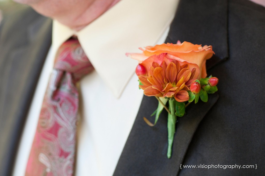 Orange boutonniere on groomsmen at fall wedding