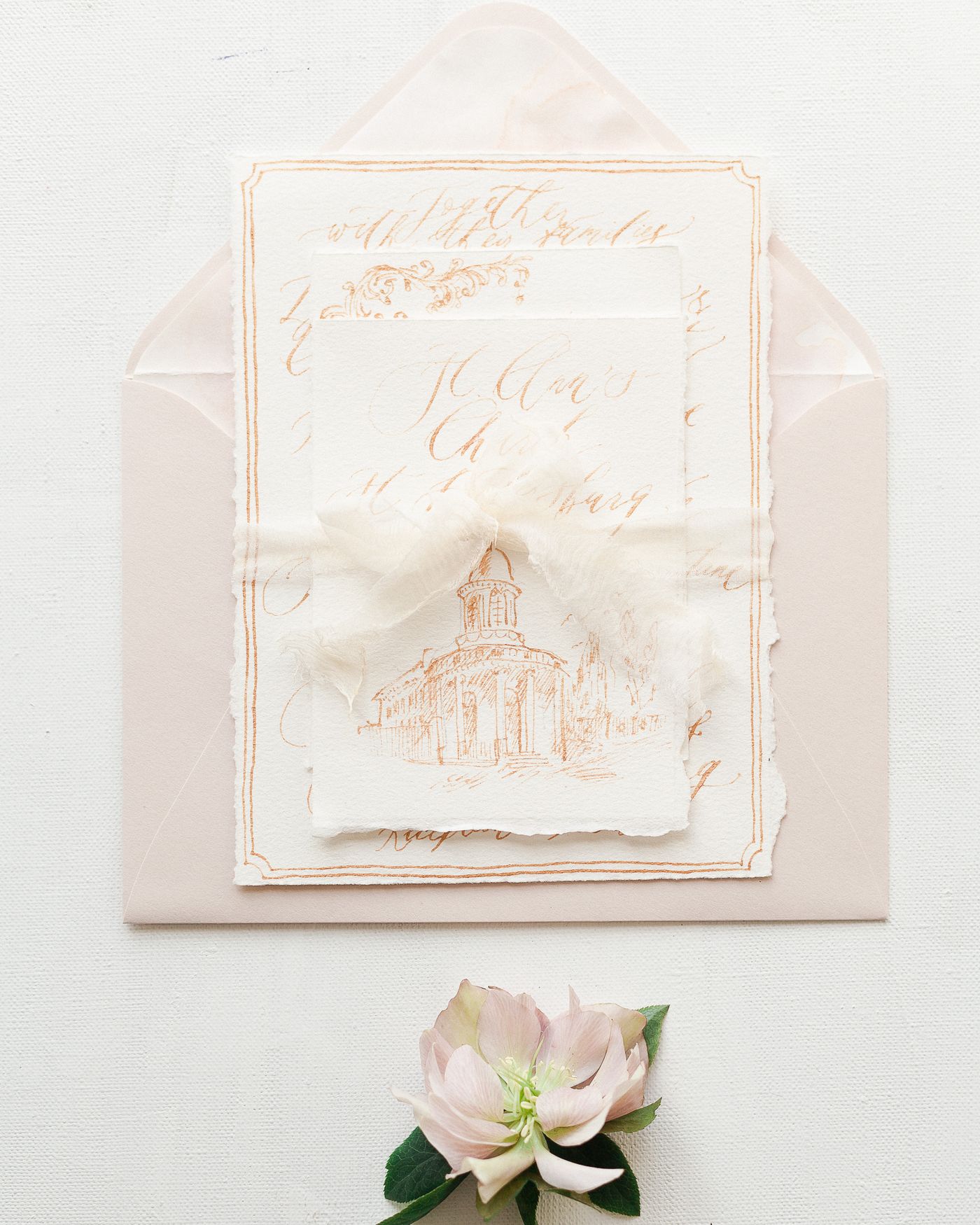 Elegant calligraphy invitations with an envelope and flower