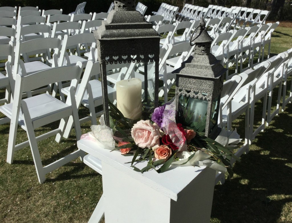 Outdoor wedding ceremondy flowers and candles by Atlanta florist Design House Flowers two