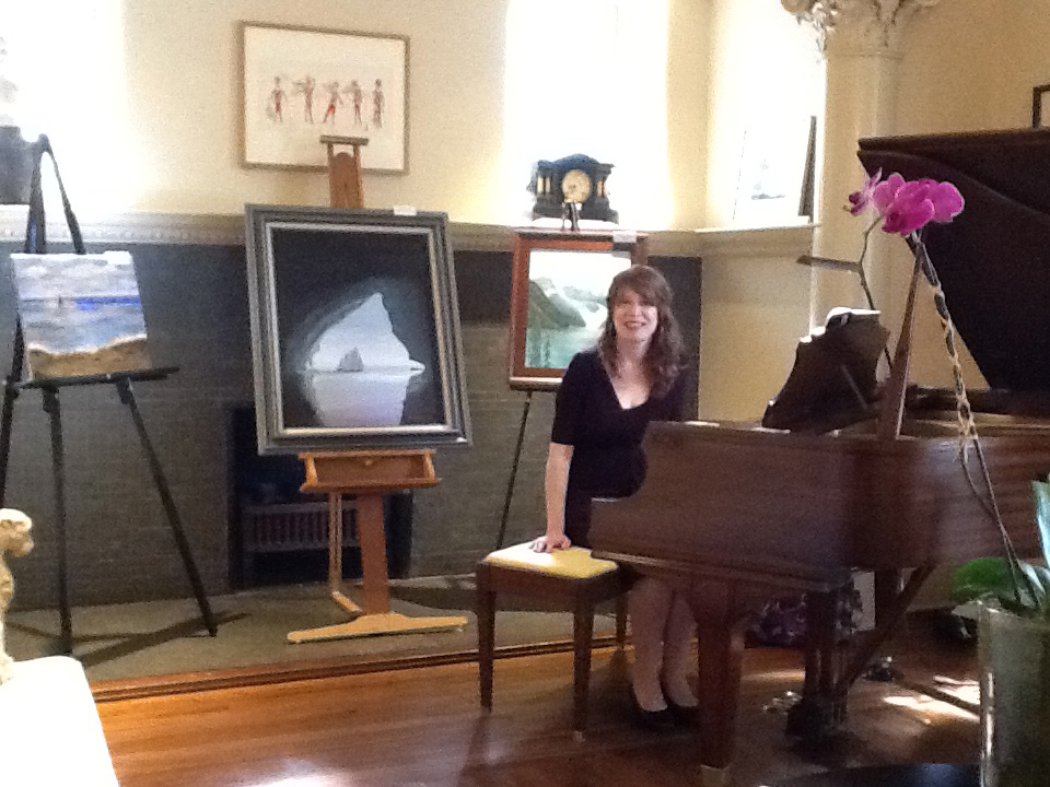 Jenny seated at the grand piano at Stonehurst Place in Atlanta