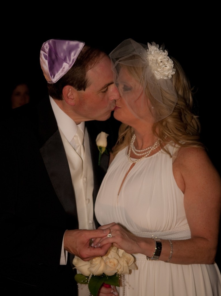 Bride and groom kissing at Jewish wedding ceremony in Atlanta