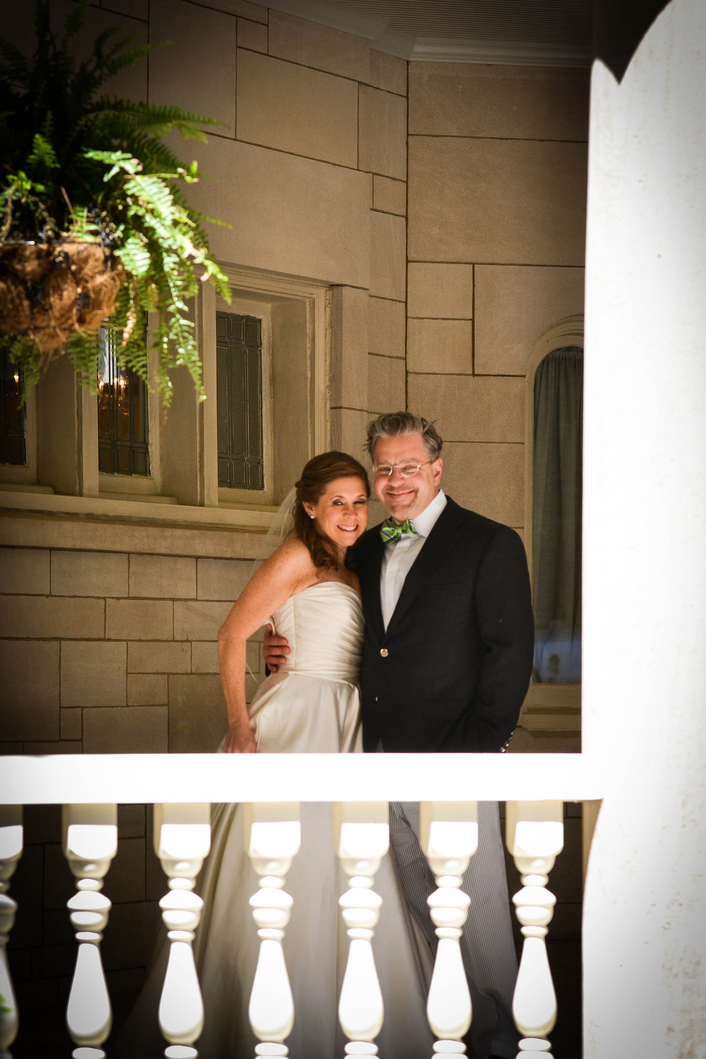 Bride and groom standing on outdoor balcony at Wimbish House on Peachtree Street