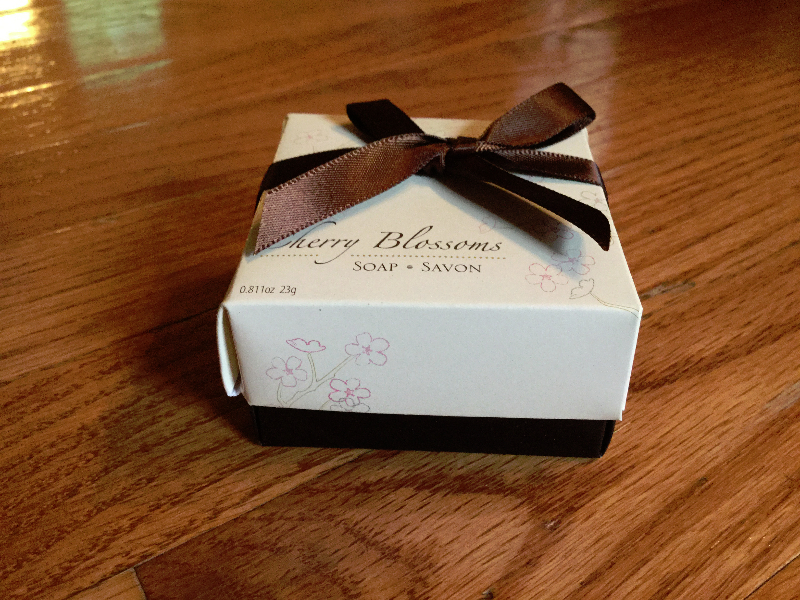 A cherry-blossom soap favor in a ribbon-tied presentation box