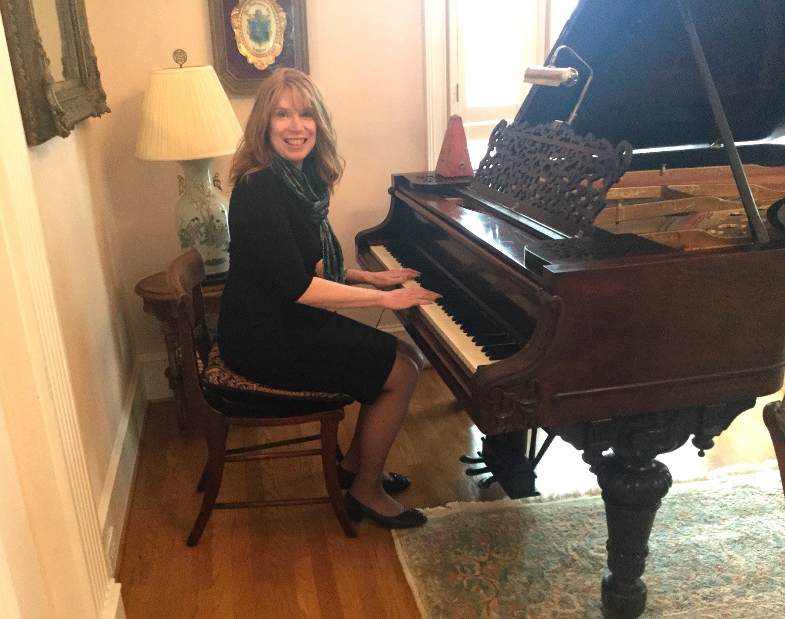 Jenny playing an antique grand piano at an anniversary party