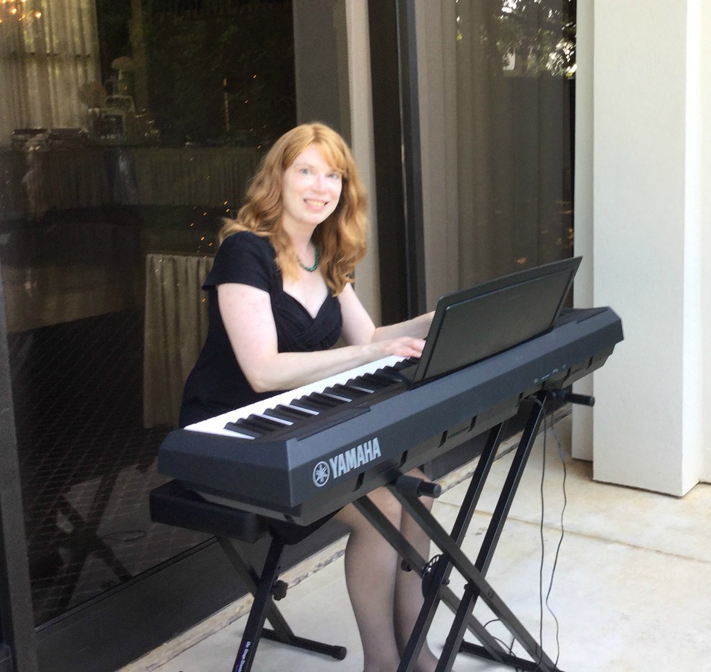 Jenny smiling at her digital piano during an event