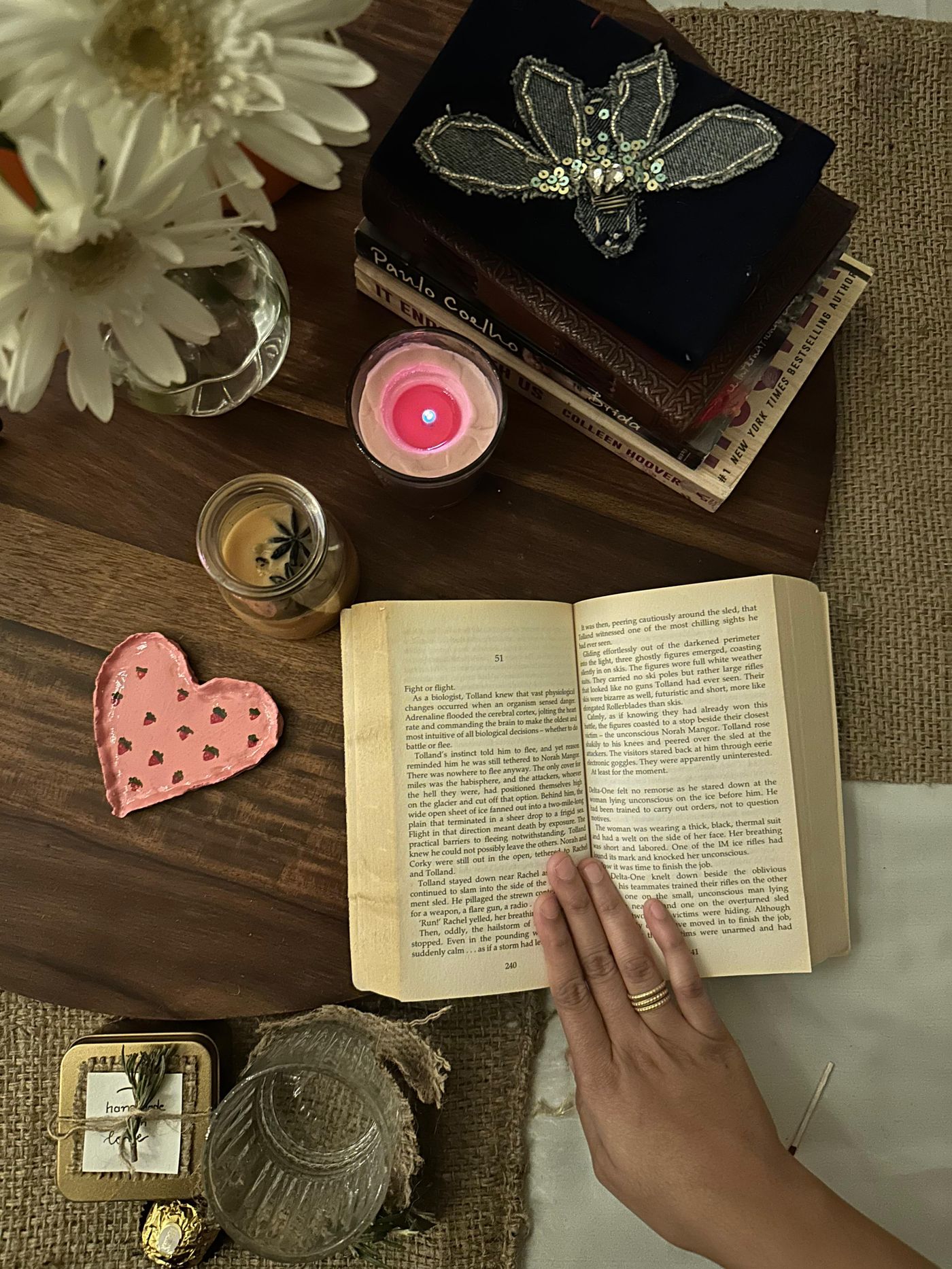 Books, flowers and candlelight arranged for a quiet reading break