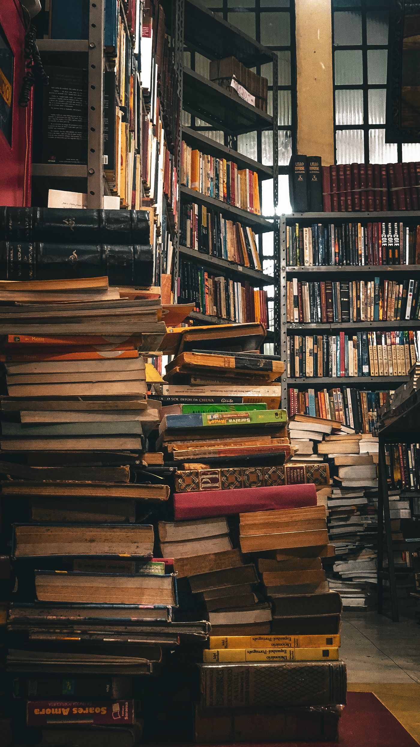 Stacks of books in a warmly lit library
