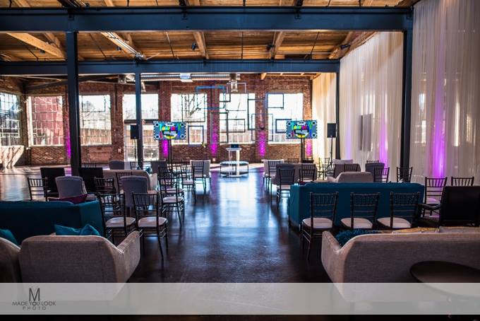 Reception tables beneath the timber ceiling at the Foundry at Puritan Mill in Atlanta