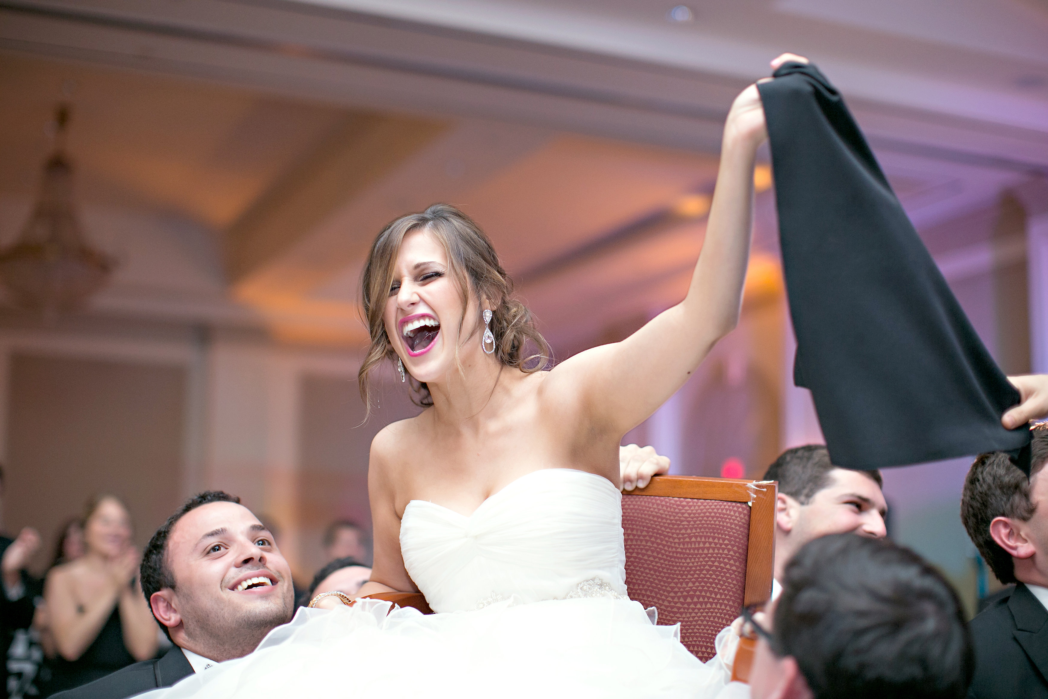 Bride at traditional Hora Chair Dance at Jewish wedding The Temple Atlanta
