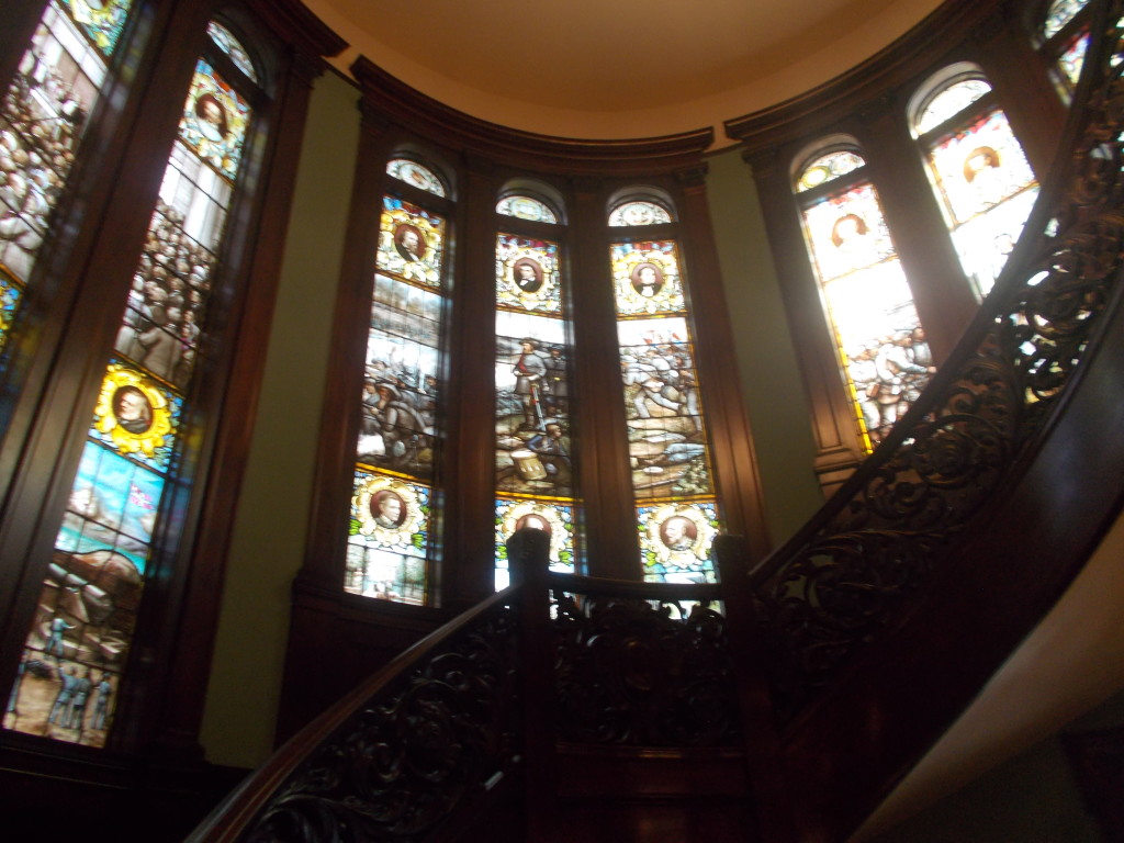 Beautiful stained glass windows around spiral staircase at Atlanta wedding venue Rhodes Hall