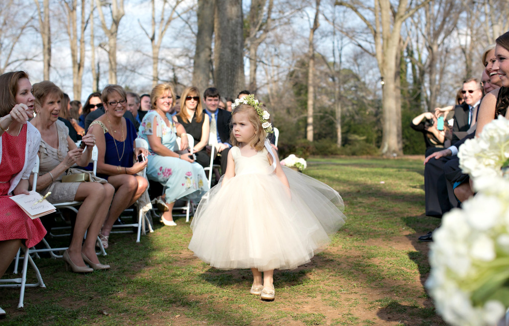 Flower girl walking down aisle at outdoor Atlanta wedding callanwolde garden fine arts center