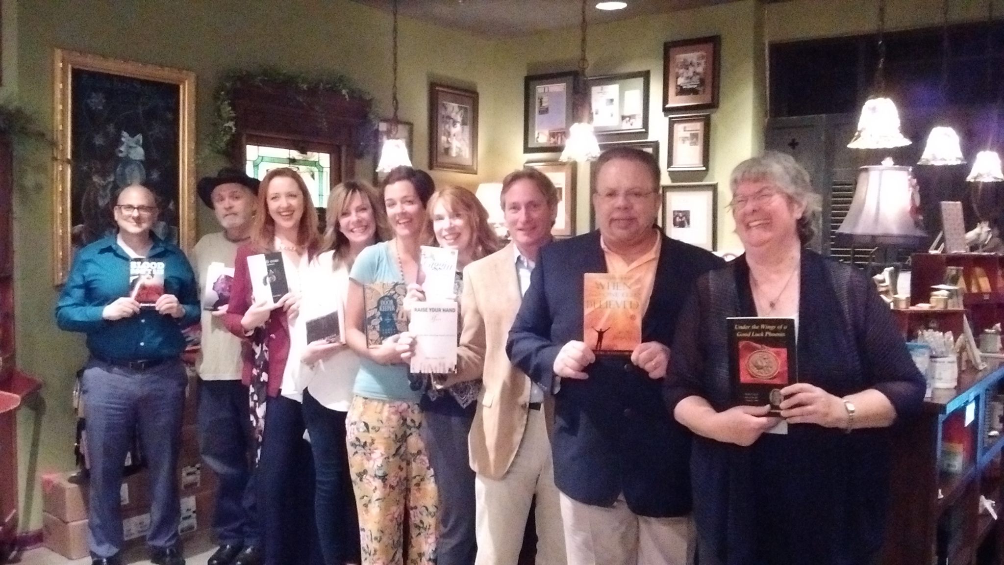Authors holding their books at an emerging-author evening at FoxTale Book Shoppe