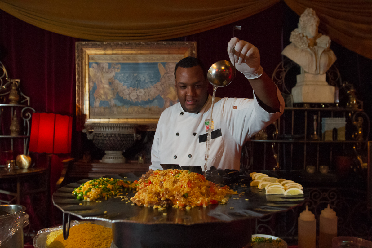 A chef preparing food inside Paris on Ponce’s Le Maison Rouge