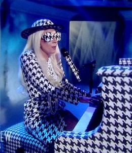 Lady Gaga playing piano black and white outfit with glasses and hat