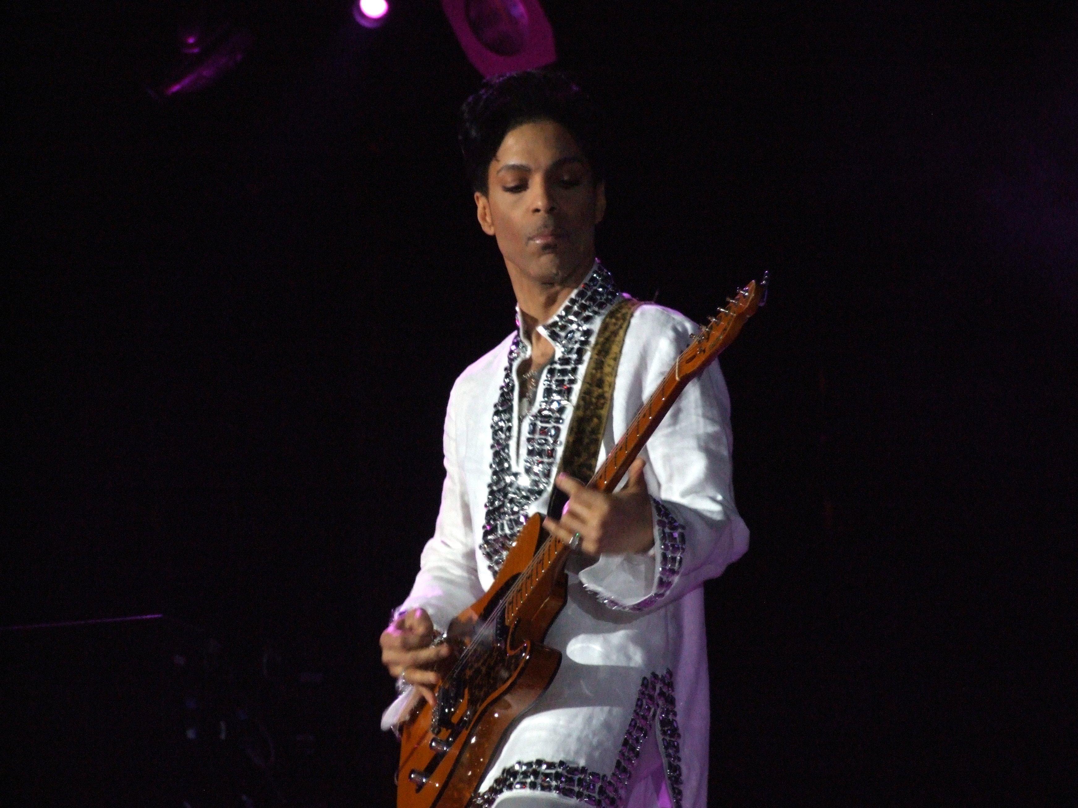 Prince performing with his guitar at Coachella in 2008