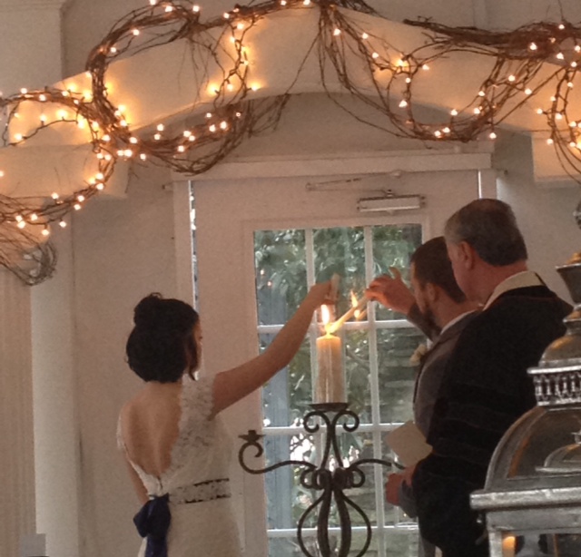 Flint Hill Wedding in historic Norcross near Atlanta lighting unity candle wearing lace wedding gown with sash